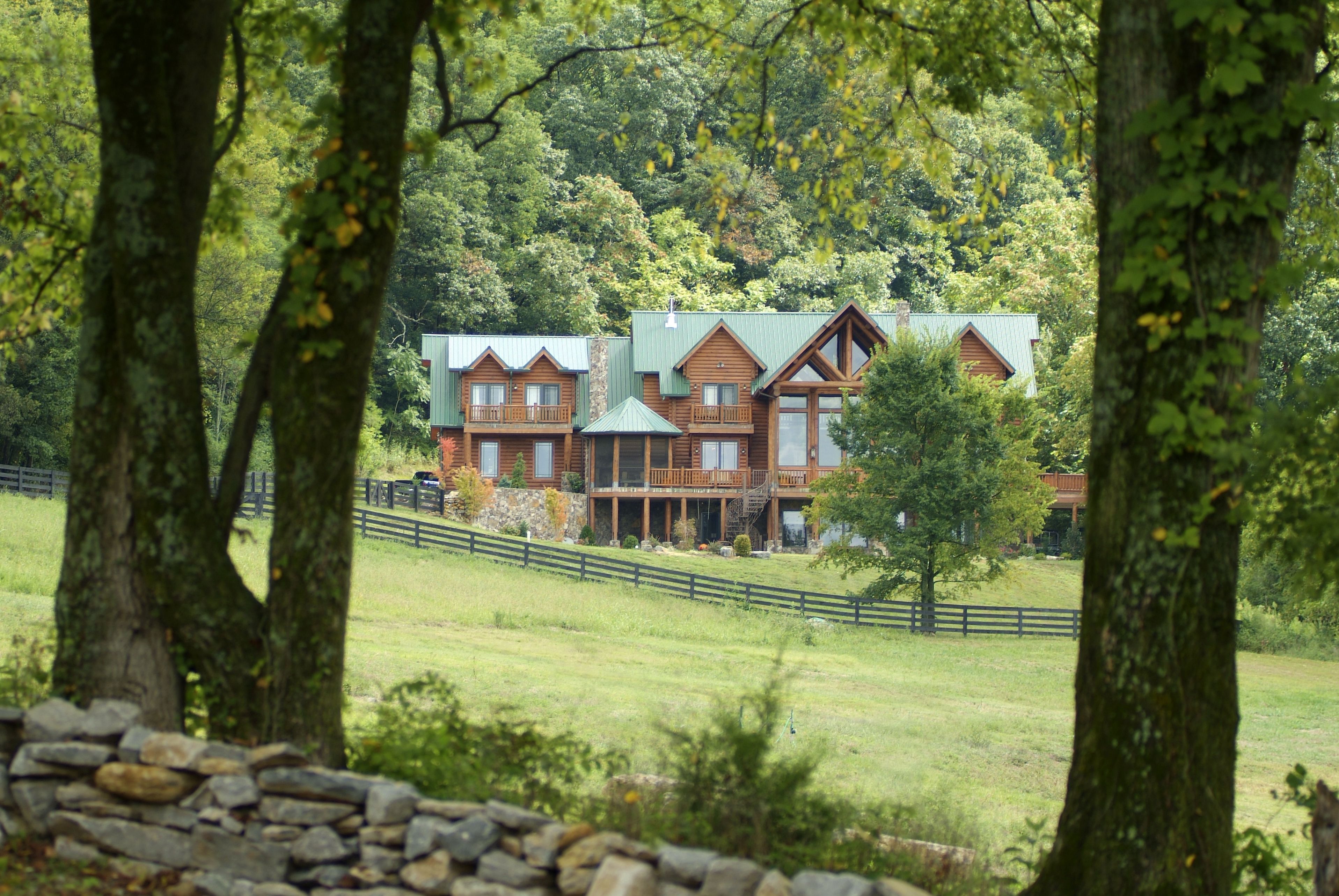 Front elevation view of a log cabin lodge built by a custom home builder in Leipers Fork, Tennessee