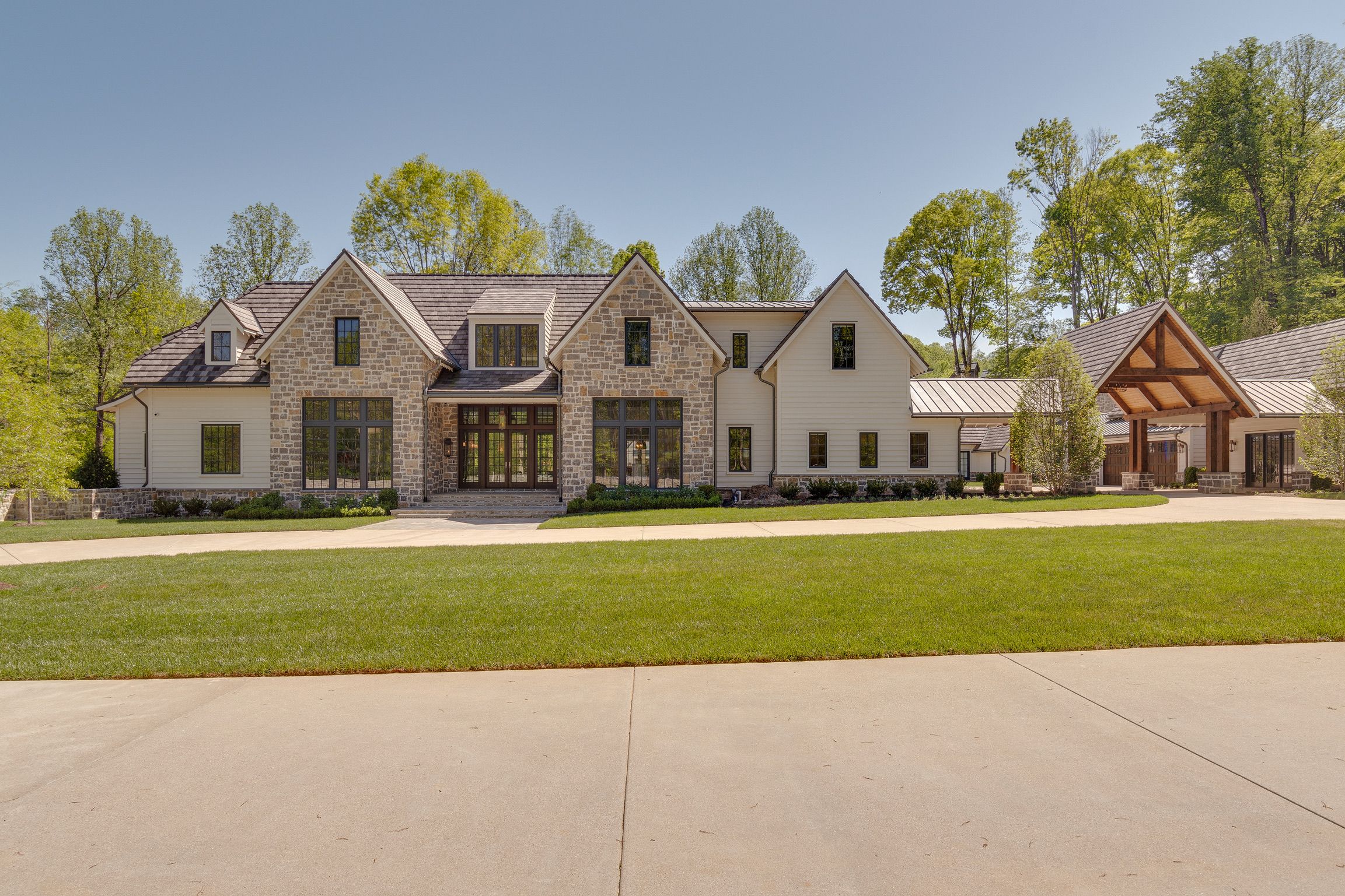 Front elevation of a modern farmhouse built by a custom home builder in Brentwood, Tennessee