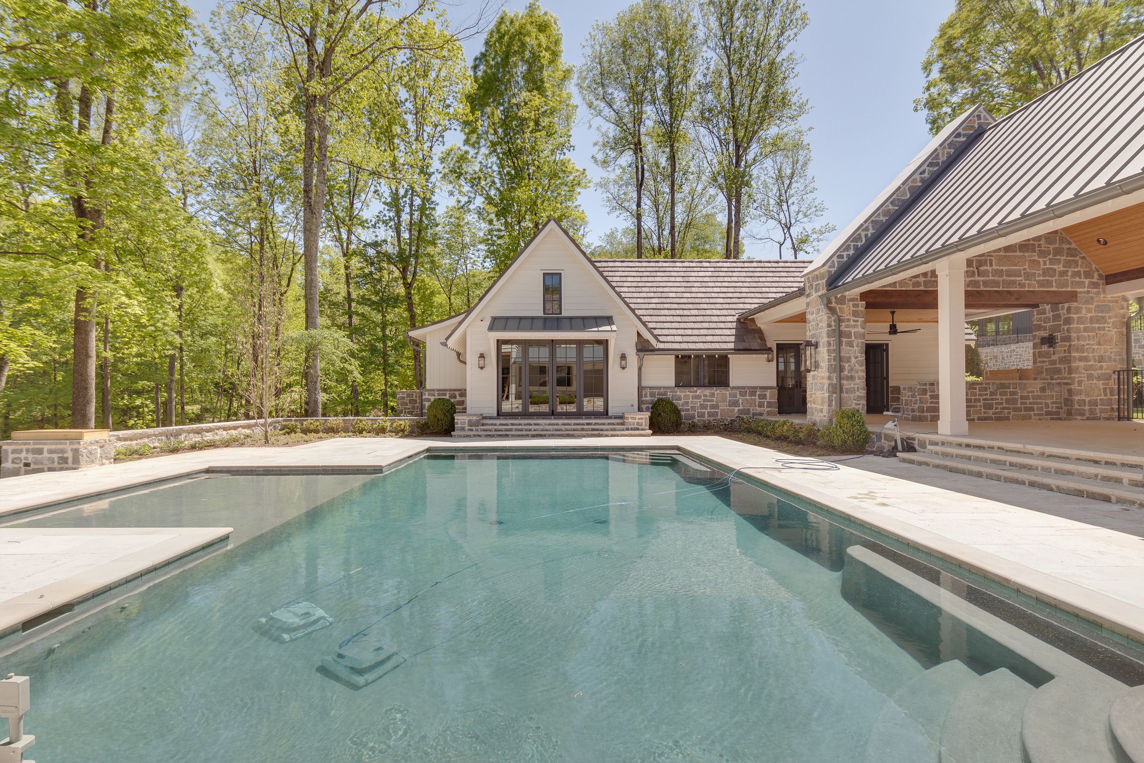 Pool area of a modern farmhouse built by a custom home builder in Brentwood, Tennessee