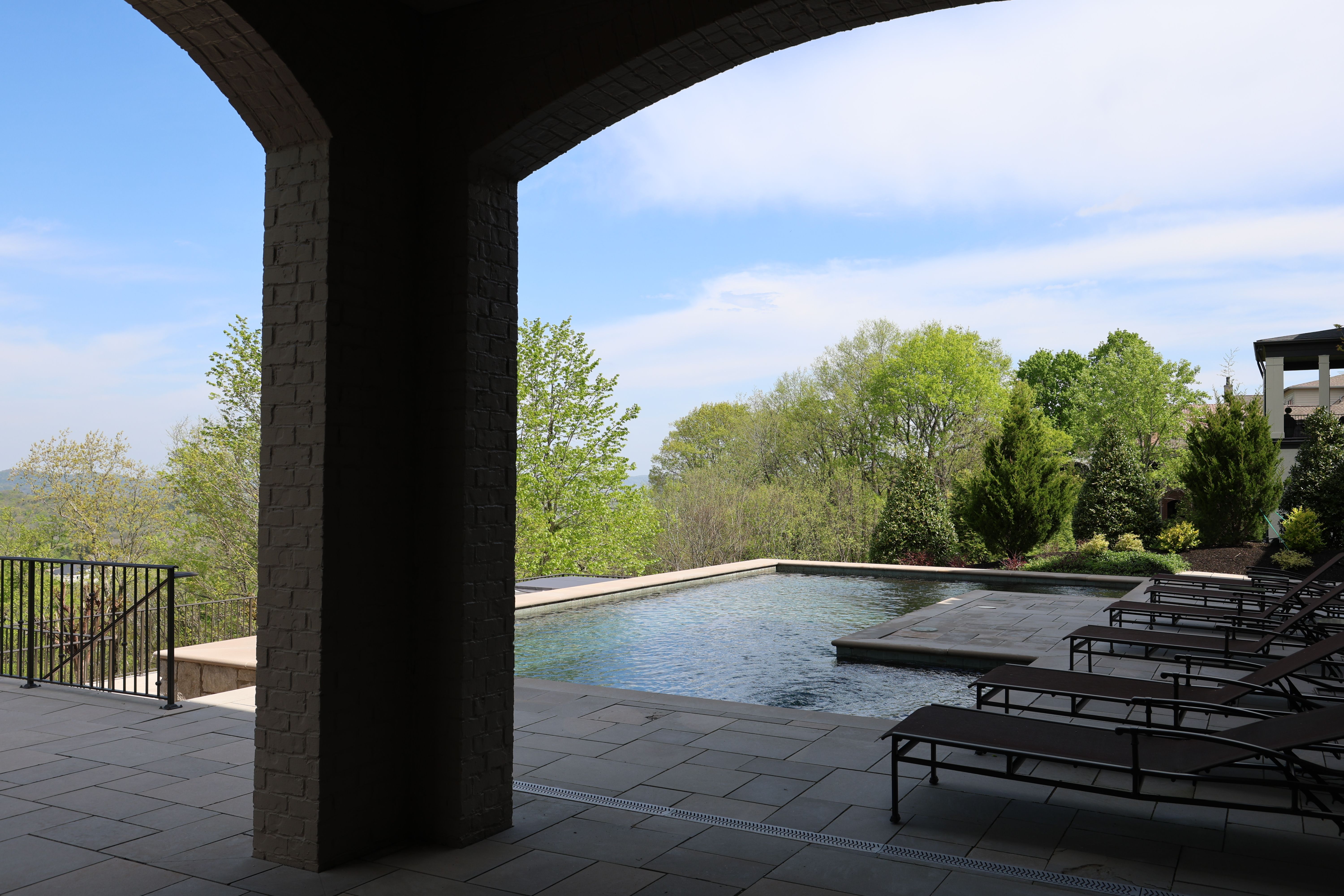 Pool view of a luxury custom european style home built by a custom home builder in Franklin, Tennessee